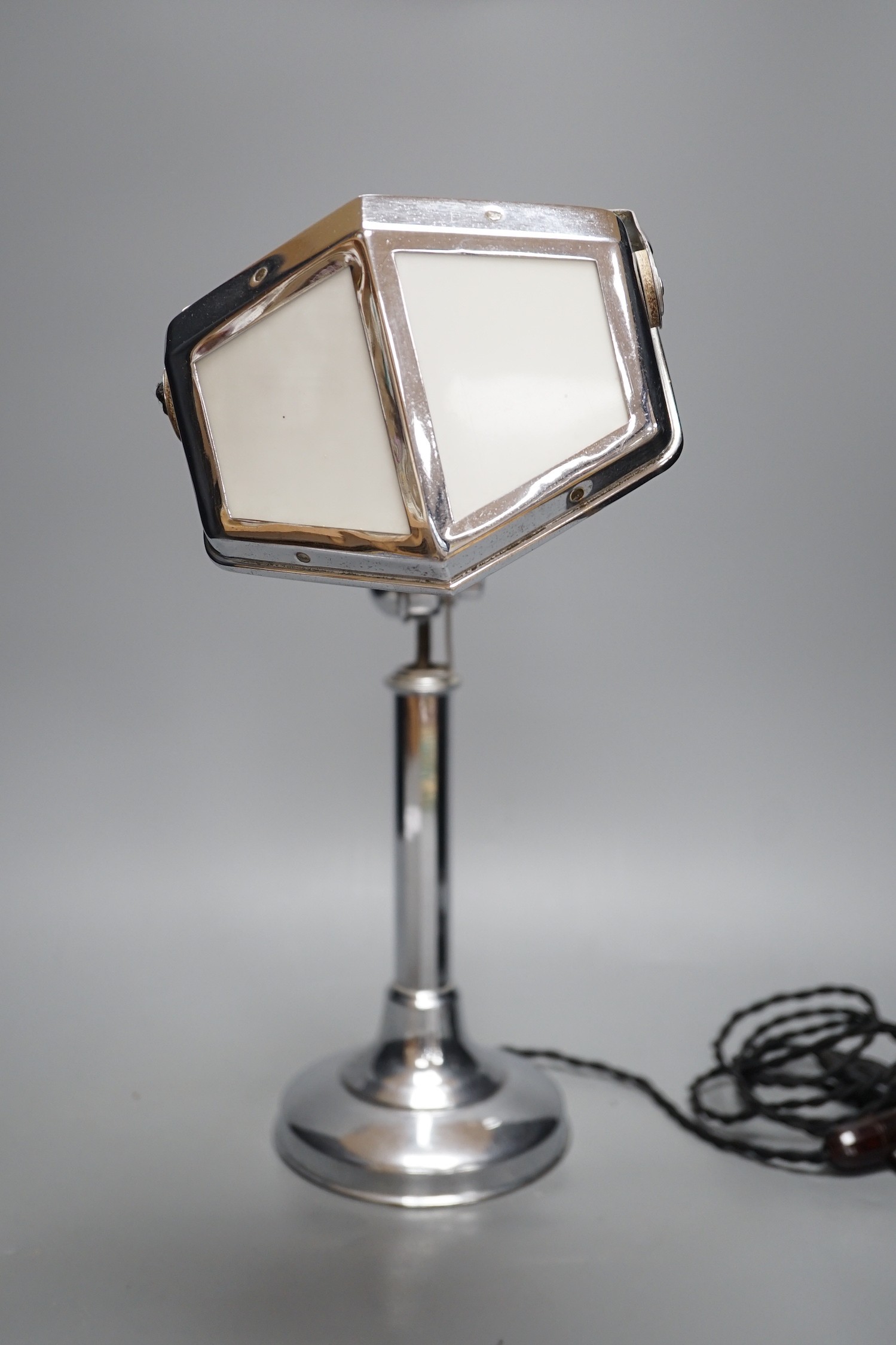 A chrome pirouette adjustable desk lamp